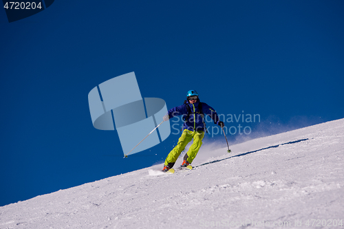 Image of Skier having fun while running downhill