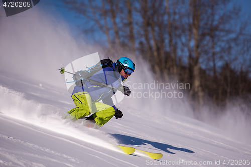 Image of Skier having fun while running downhill