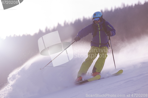 Image of Skier having fun while running downhill