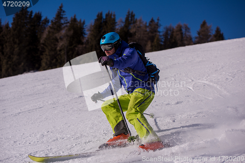 Image of Skier having fun while running downhill