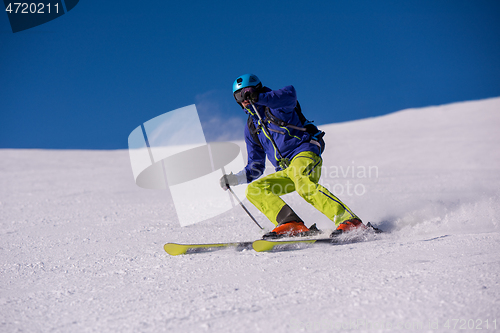 Image of Skier having fun while running downhill