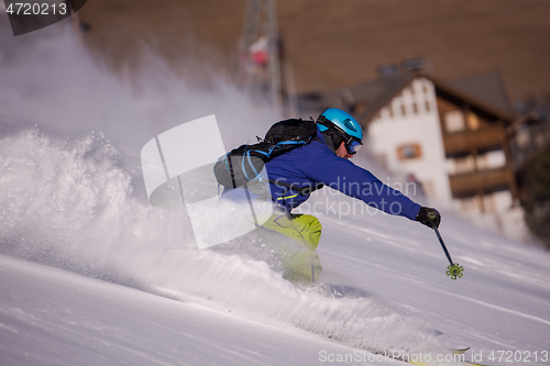 Image of Skier having fun while running downhill