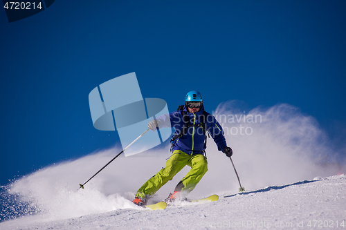 Image of Skier having fun while running downhill