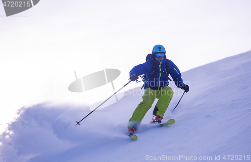 Image of Skier having fun while running downhill