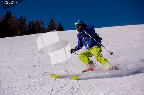 Image of Skier having fun while running downhill