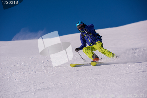 Image of Skier having fun while running downhill