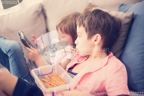 Image of cute little brother and sister having fun at home