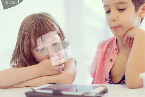 Image of cute little brother and sister having fun at home