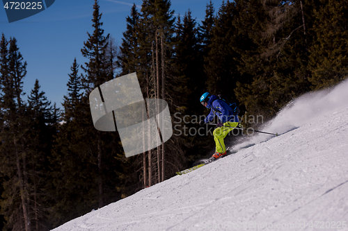 Image of Skier having fun while running downhill