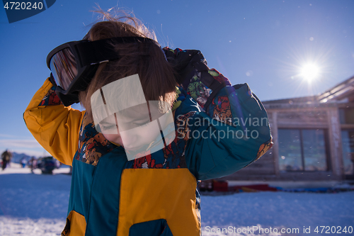 Image of little boy having a problem with ski goggles