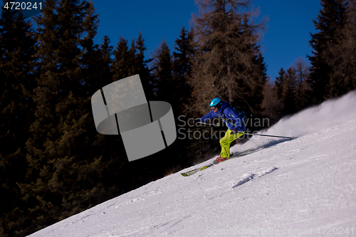 Image of Skier having fun while running downhill