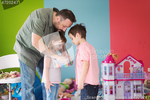 Image of sister and brother havin fun and play hairstylist game at home