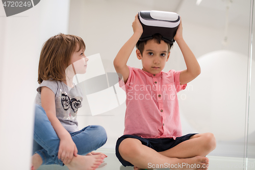 Image of kids using virtual reality headsets at home