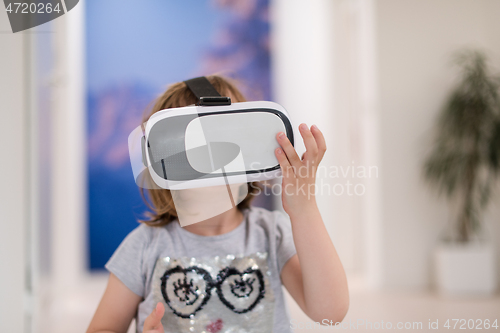 Image of little girl at home wearing vr glasses