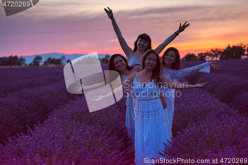 Image of group of famales have fun in lavender flower field