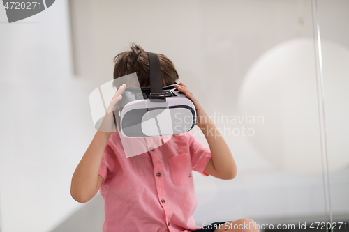 Image of kid at home playing games on vr glasses