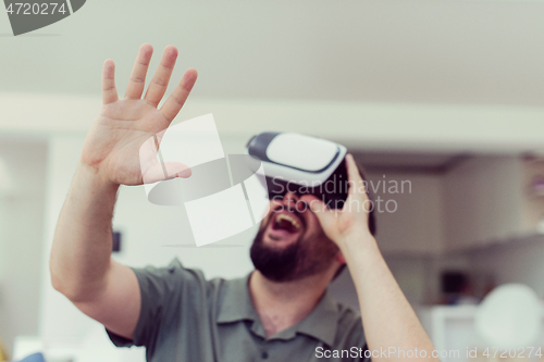 Image of man with beard trying vr glasses