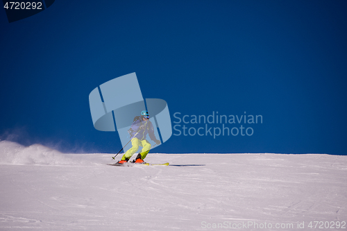 Image of Skier having fun while running downhill