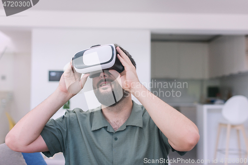 Image of man with beard trying vr glasses