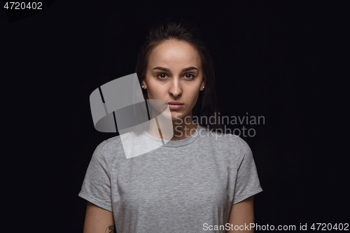 Image of Close up portrait of young woman isolated on black studio background