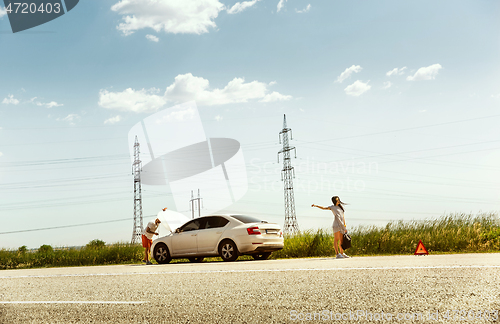 Image of Young couple traveling on the car in sunny day