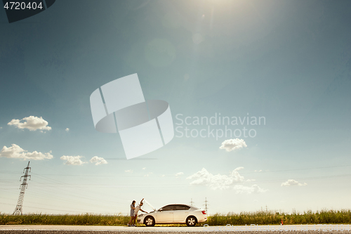 Image of Young couple traveling on the car in sunny day