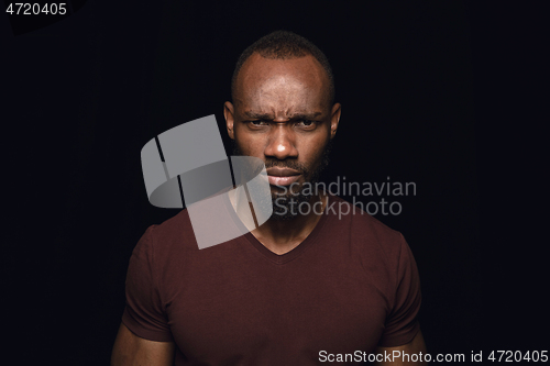 Image of Close up portrait of young man isolated on black studio background