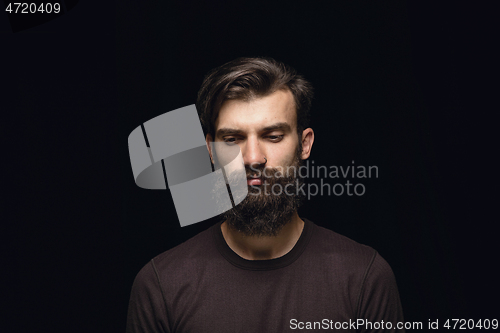 Image of Close up portrait of young man isolated on black studio background