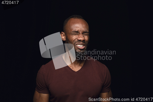 Image of Close up portrait of young man isolated on black studio background