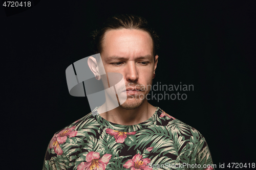 Image of Close up portrait of young man isolated on black studio background