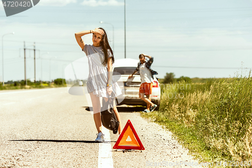 Image of Young couple traveling on the car in sunny day