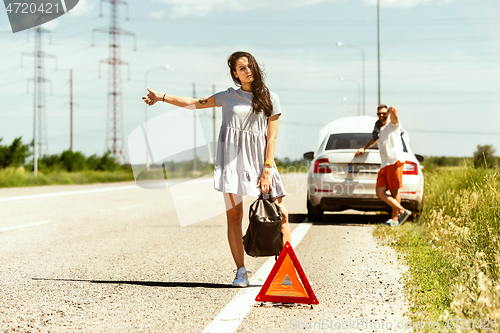 Image of Young couple traveling on the car in sunny day