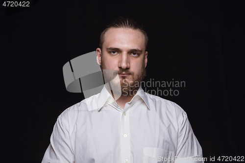 Image of Close up portrait of young man isolated on black studio background