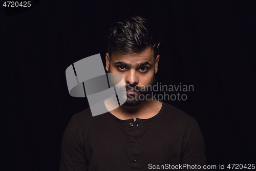 Image of Close up portrait of young man isolated on black studio background