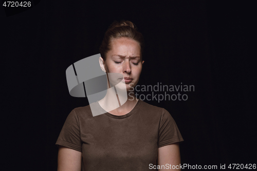 Image of Close up portrait of young woman isolated on black studio background