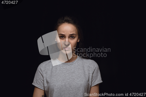 Image of Close up portrait of young woman isolated on black studio background
