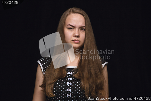 Image of Close up portrait of young woman isolated on black studio background