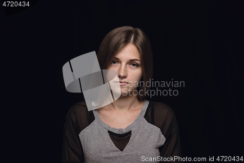 Image of Close up portrait of young woman isolated on black studio background