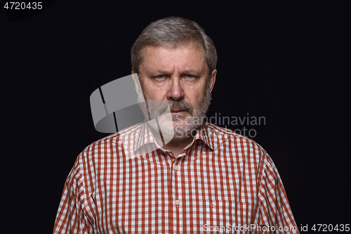 Image of Close up portrait of senior man isolated on black studio background