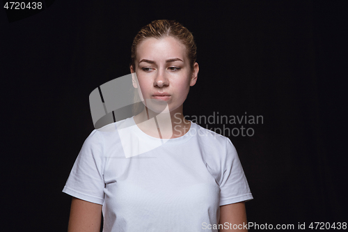 Image of Close up portrait of young woman isolated on black studio background