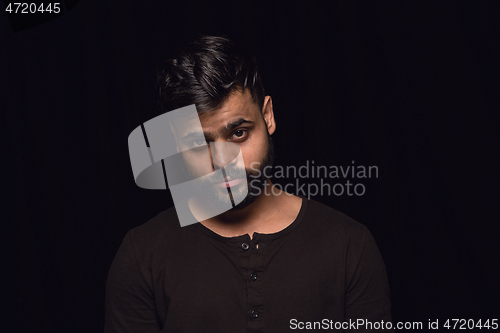 Image of Close up portrait of young man isolated on black studio background