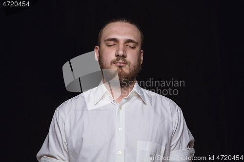 Image of Close up portrait of young man isolated on black studio background