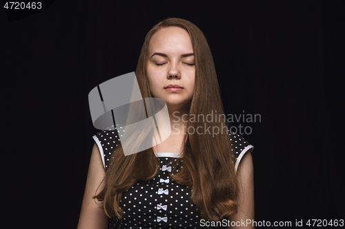 Image of Close up portrait of young woman isolated on black studio background