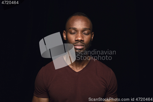 Image of Close up portrait of young man isolated on black studio background