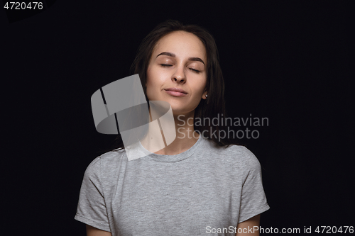 Image of Close up portrait of young woman isolated on black studio background