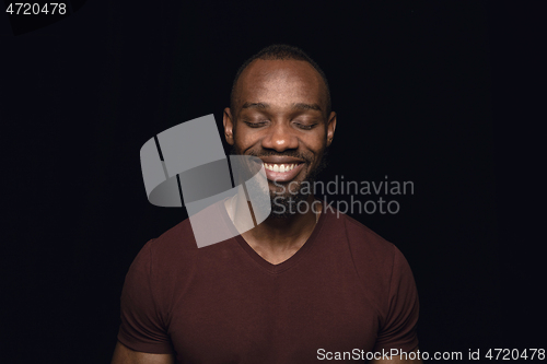 Image of Close up portrait of young man isolated on black studio background