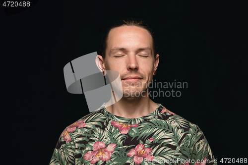 Image of Close up portrait of young man isolated on black studio background