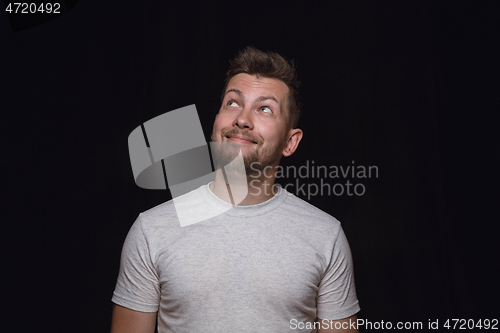 Image of Close up portrait of young man isolated on black studio background