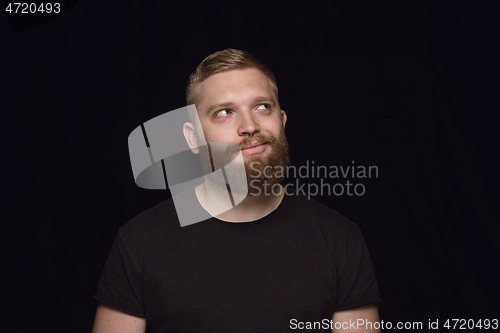 Image of Close up portrait of young man isolated on black studio background