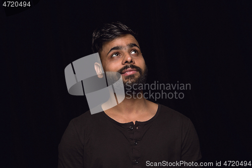 Image of Close up portrait of young man isolated on black studio background